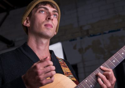 Sam Lily, lost in a day dream, strumming a Bm7