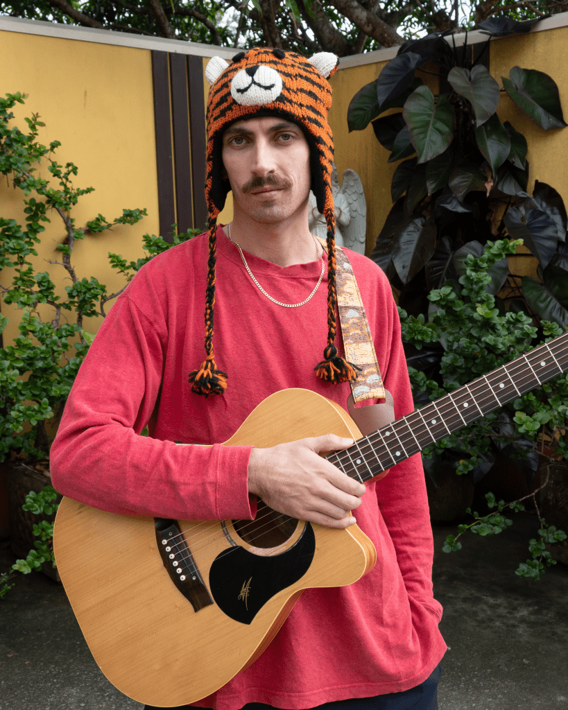 Sam Lily with a guitar tiger hat